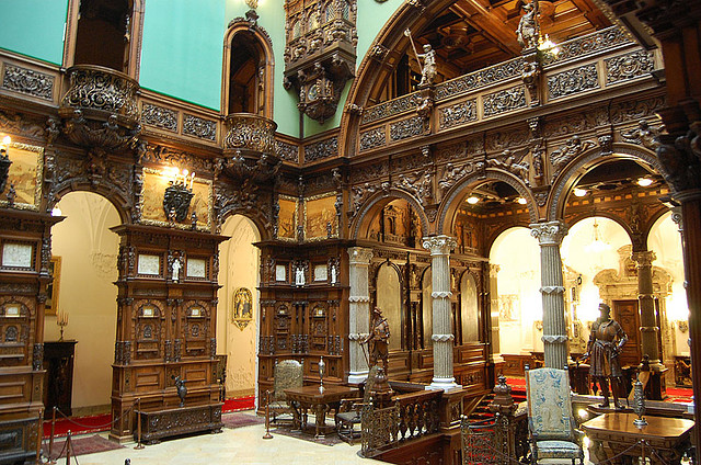 Peles Castle rising against the forested Carpathian peaks