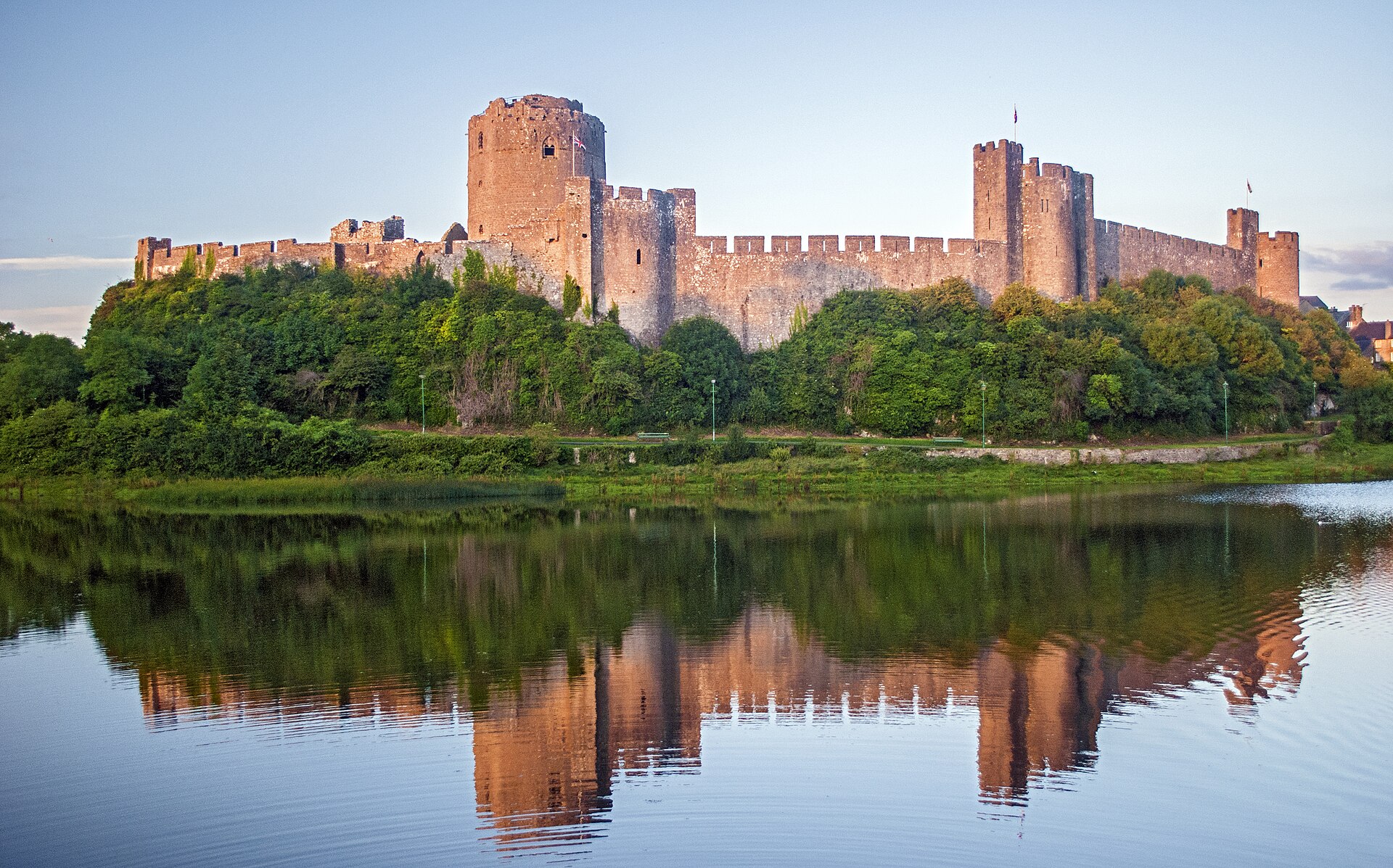 Pembroke's high walls and towers rising sheer above the water on three sides