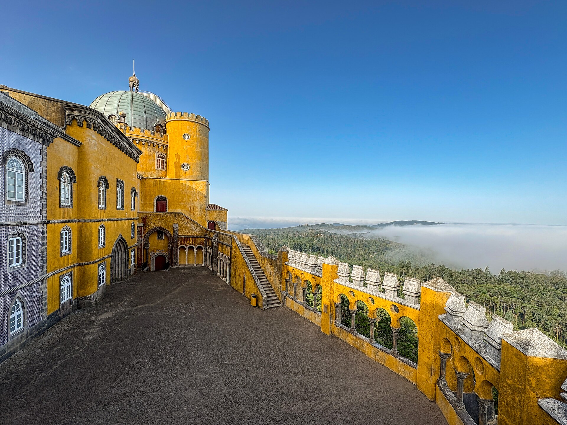 The palace rising above a sea of morning cloud