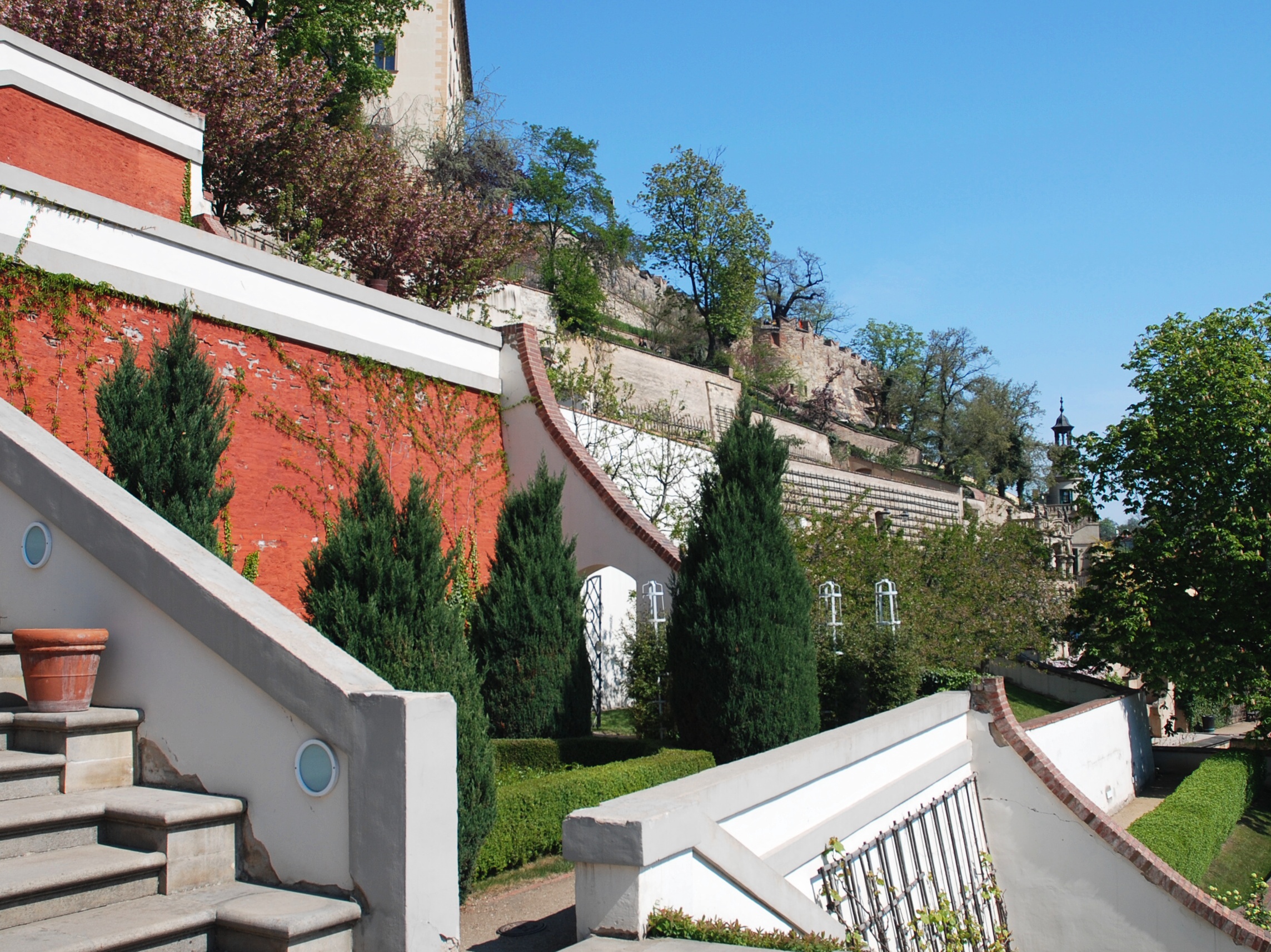Terraced gardens spill down the castle's southern slope toward the Lesser Town below.