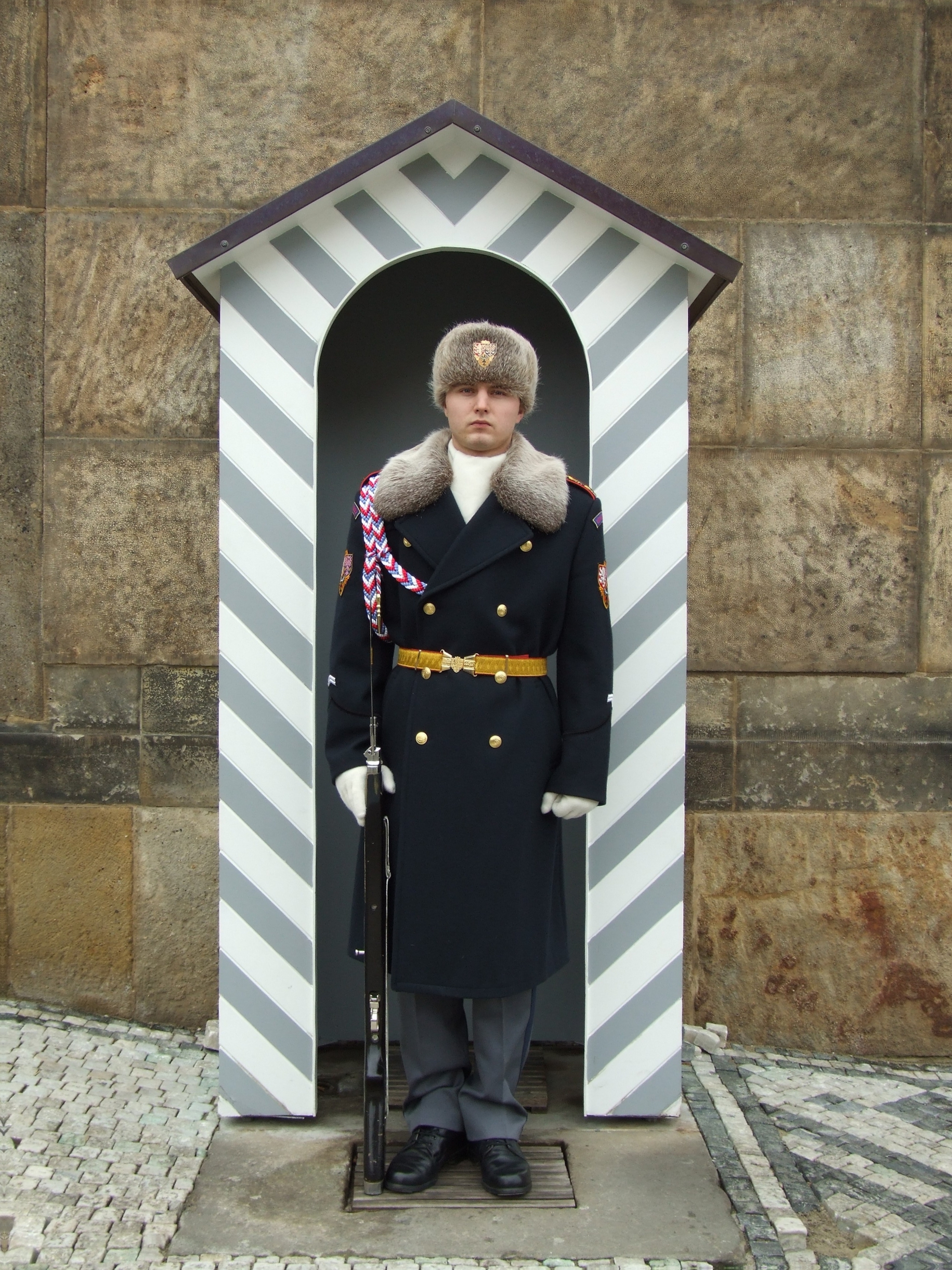 A castle guard stands watch, heir to centuries of ceremony that reached a peak under Emperor Rudolf II.