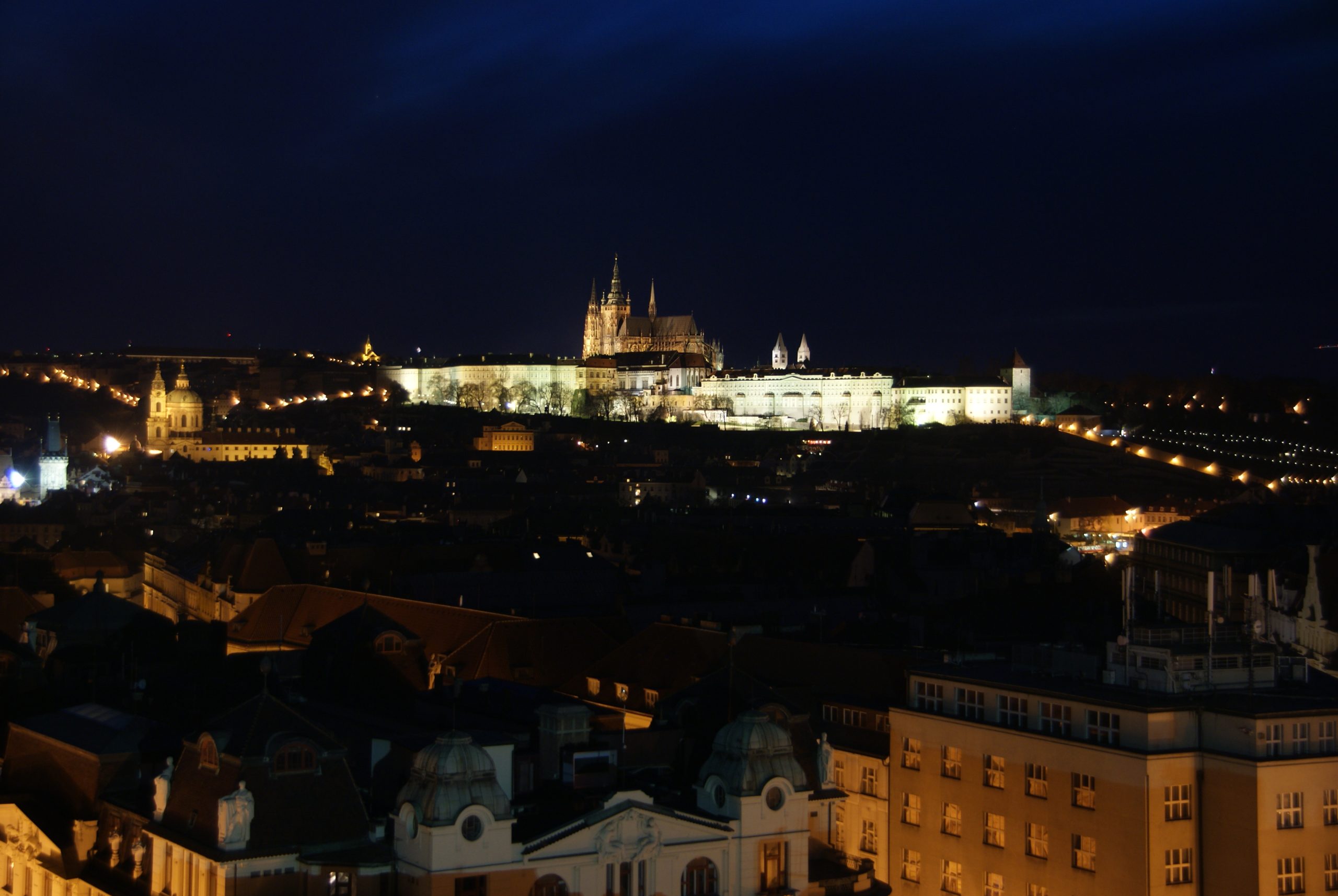 Floodlit at night, the castle still functions as the working seat of the Czech head of state.