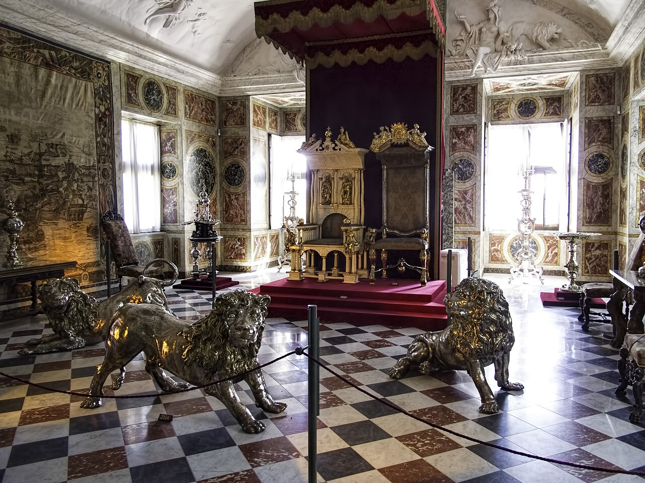 The three silver lions that guard the thrones.