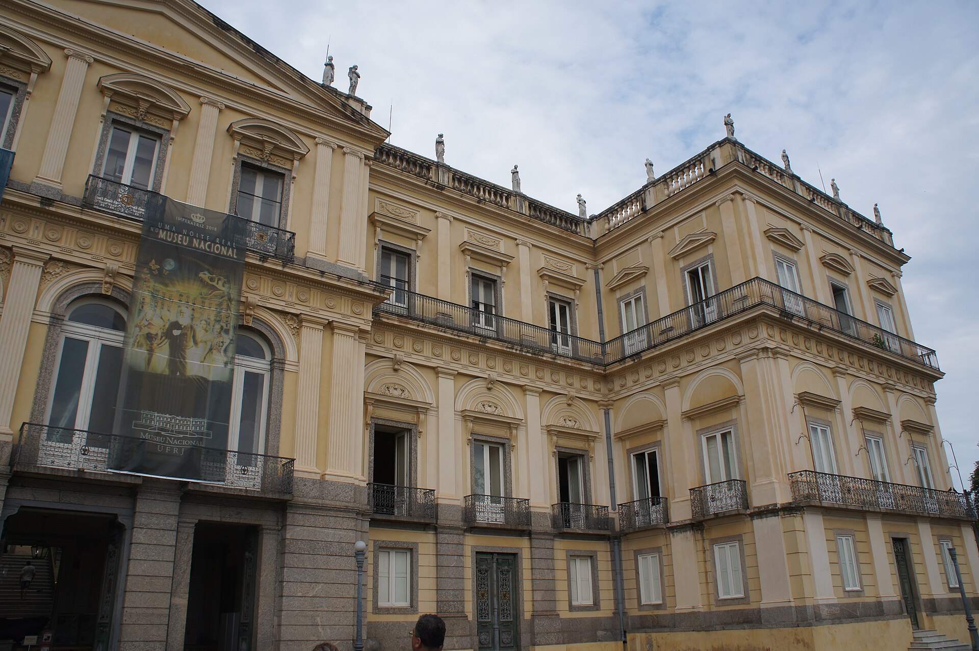A partial view of the palace facade, rising above its park.