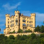 Schloss Hohenschwangau glowing yellow against the Bavarian mountains