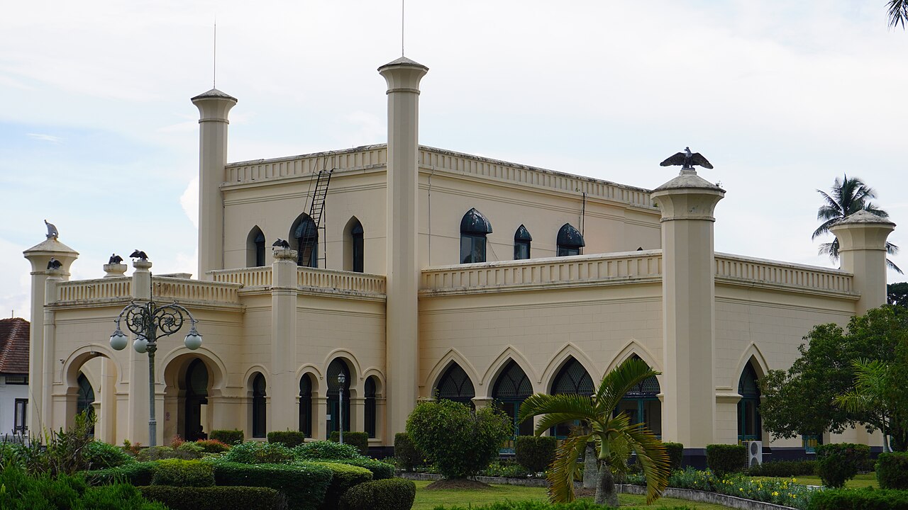 The Istana Siak gleaming beside the river