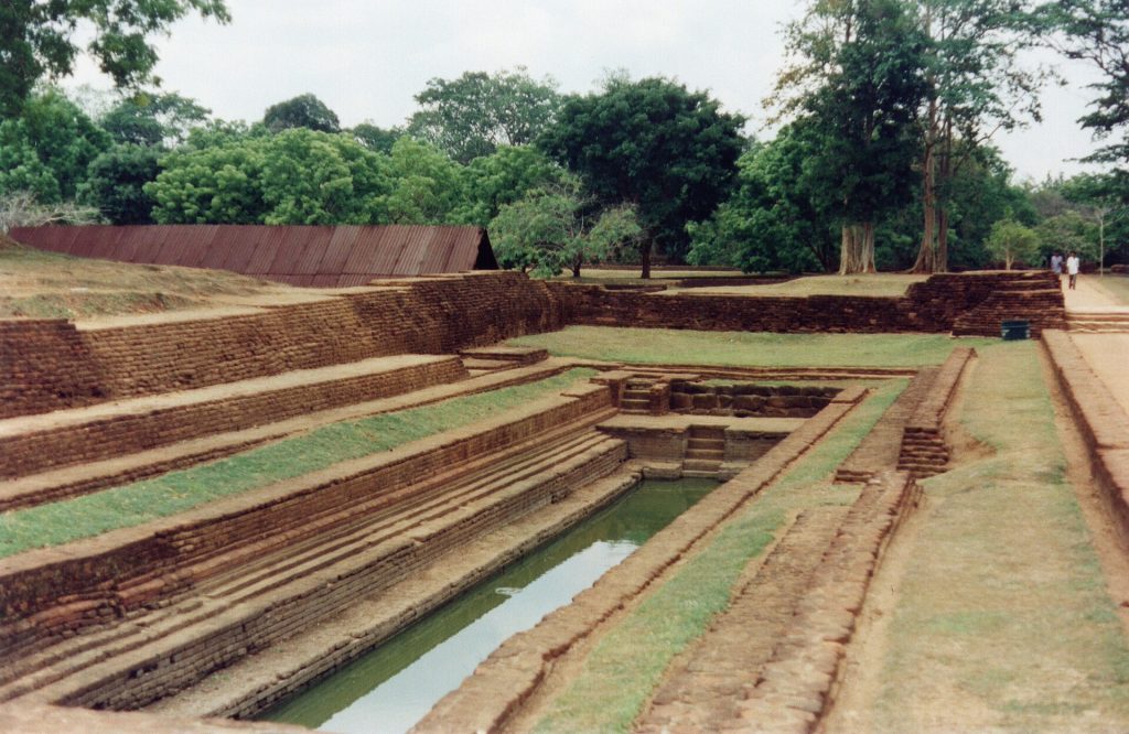 The geometric water gardens spread before the great rock