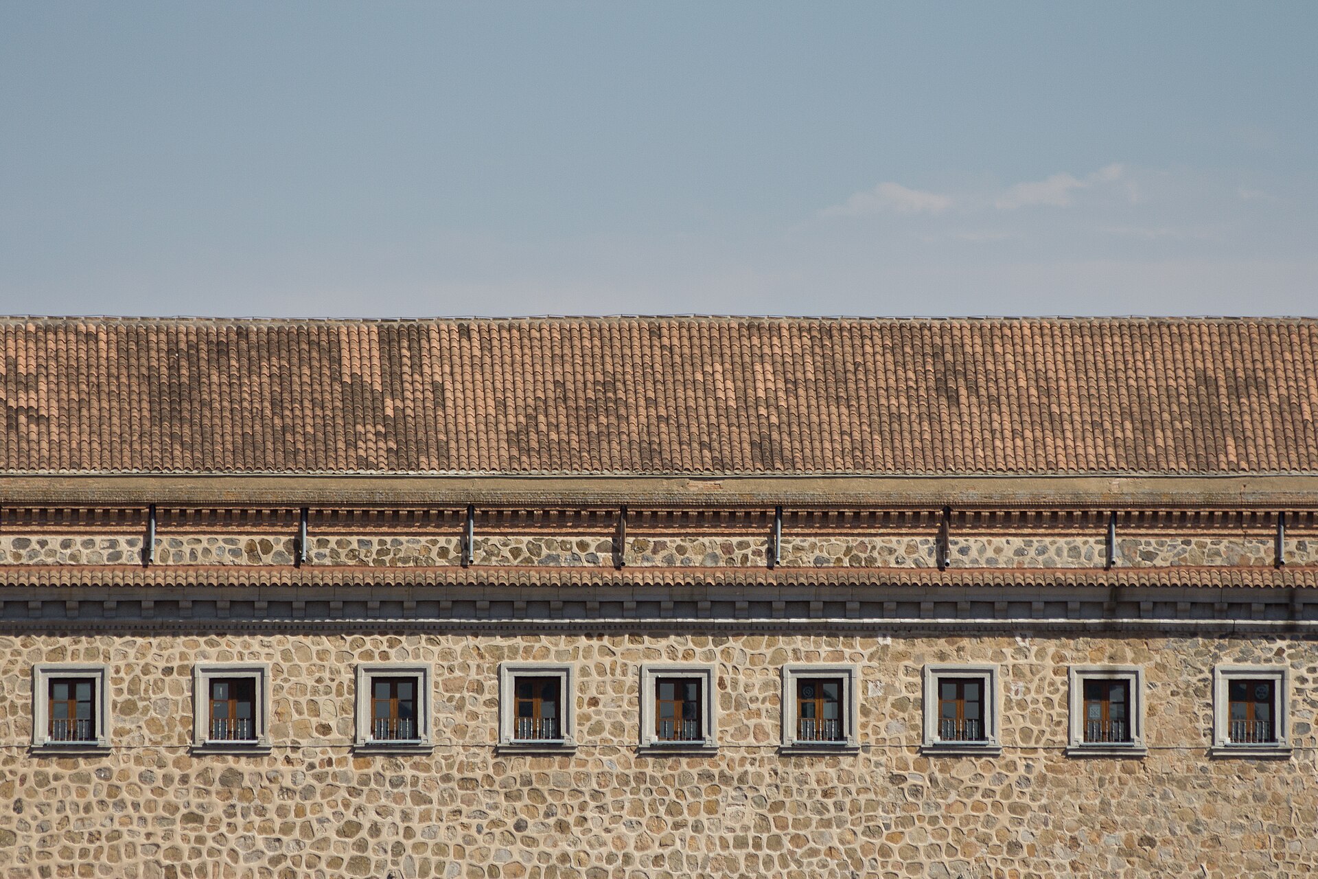 The palace forms a great square, each of its four faces in a different style.
