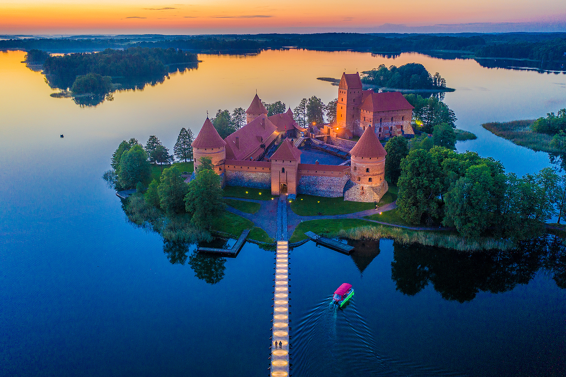 The castle rising from its island in the lake
