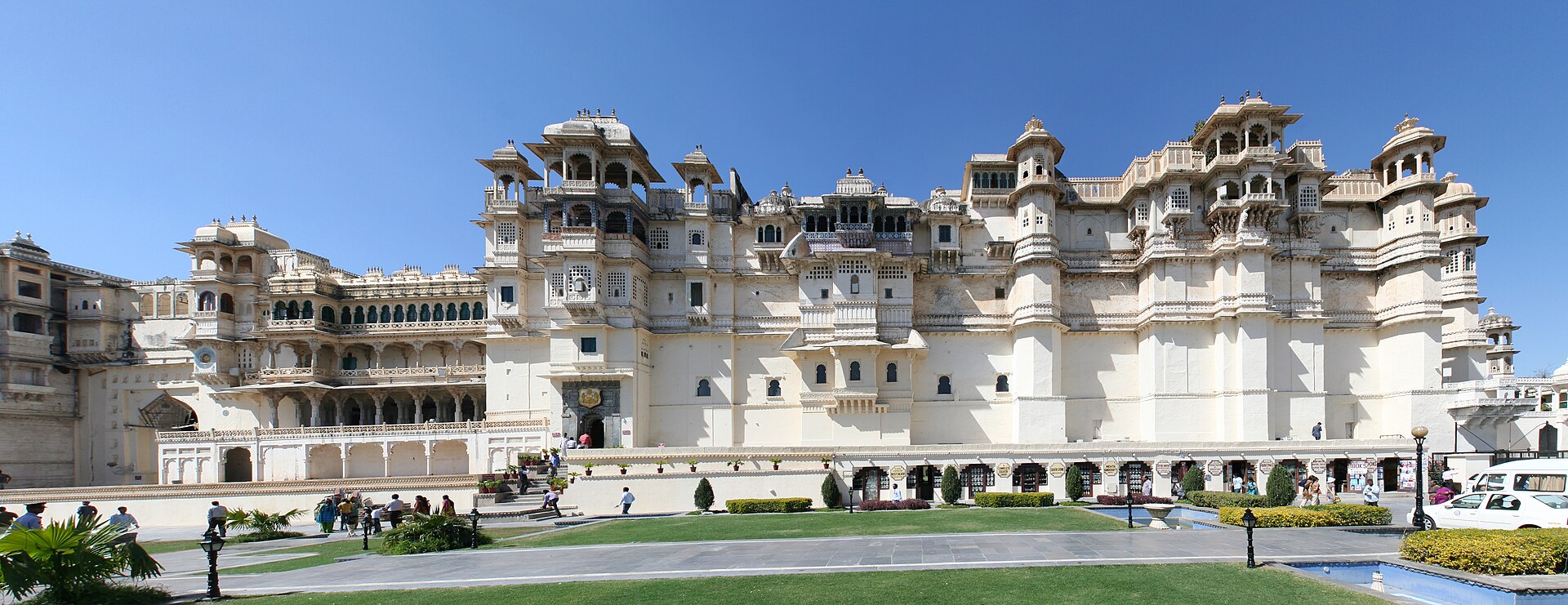 The City Palace of Udaipur rising in tiers of pale stone above the shining waters of Lake Pichola.