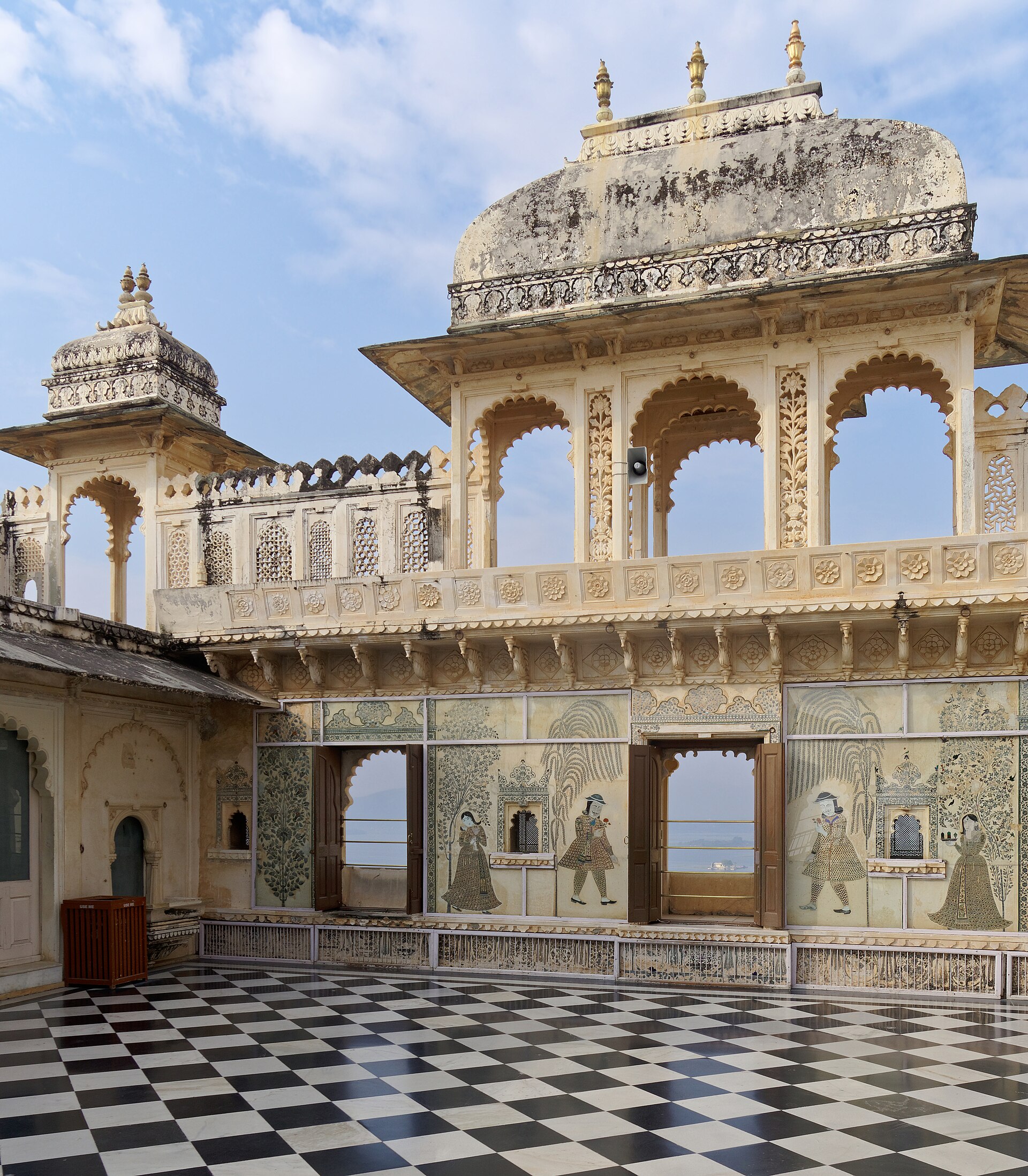 A courtyard of the City Palace, its walls enriched with carved and inlaid ornament.