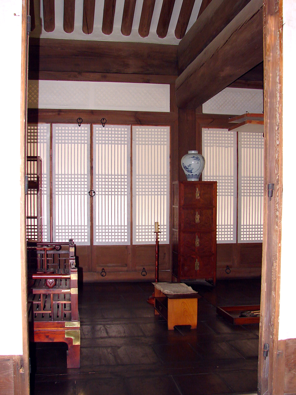 Timber halls and tiled eaves of the compound
