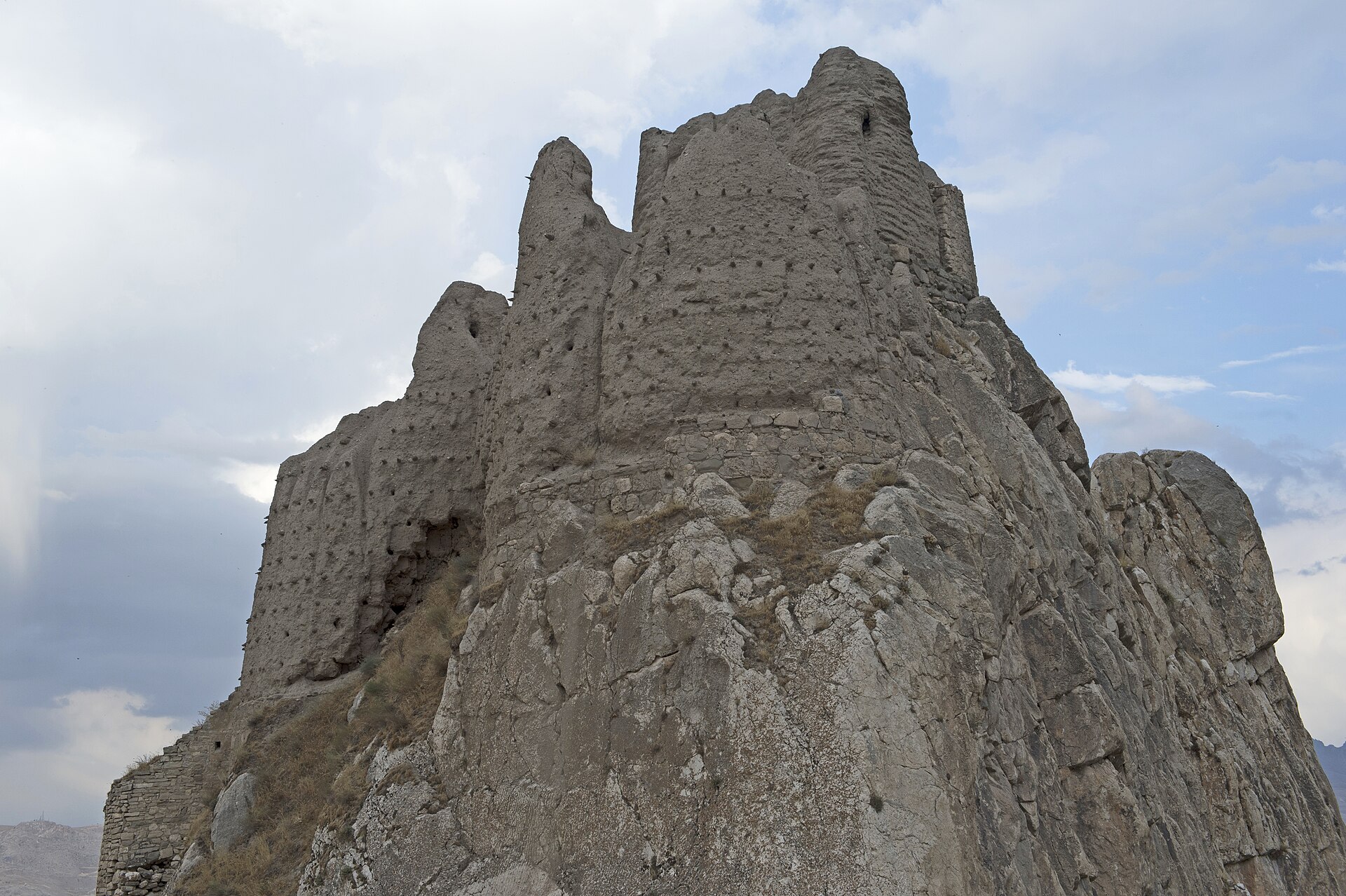 The lower walls were built of massive, unmortared basalt blocks in the cyclopean style.