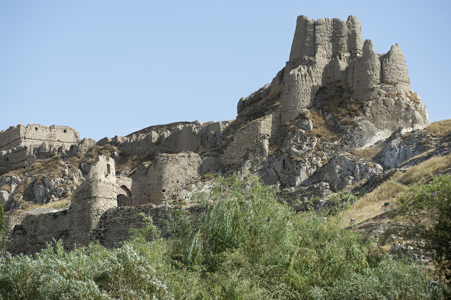 High on the cliff, the Persian king Xerxes left a famous trilingual cuneiform inscription.