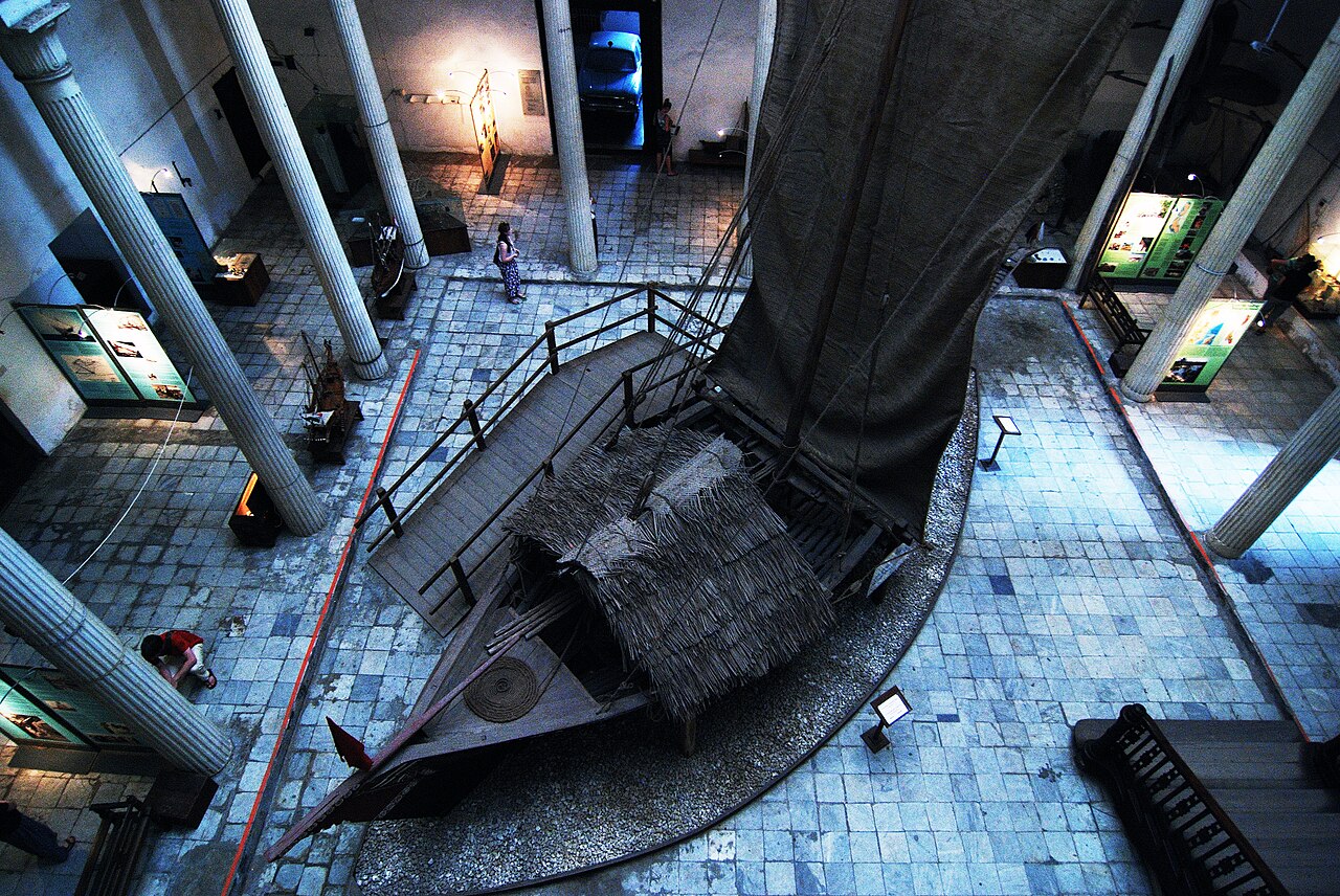 Inside the House of Wonders, beneath its galleried halls.