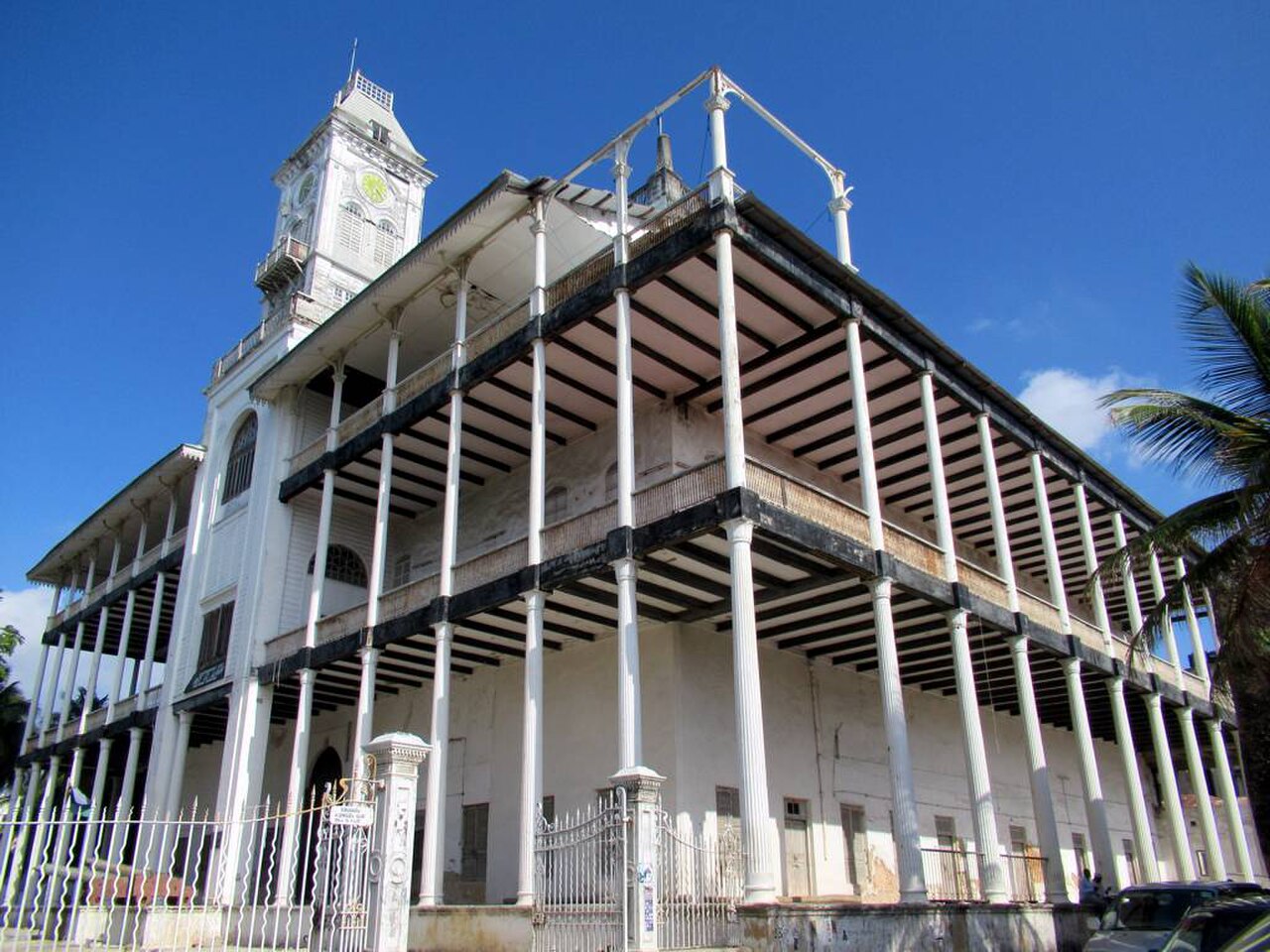 The tiered verandas and clock tower rising over the waterfront.
